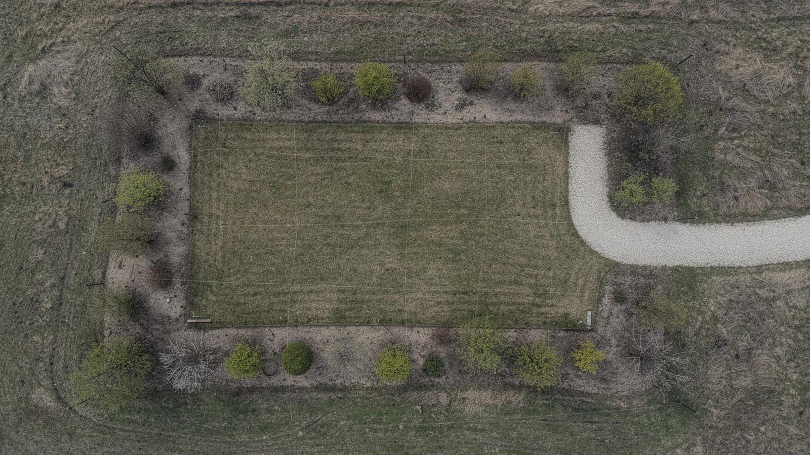 Aerial view of a surveyed countryside plot with contour lines marked across mown lawn and shrub beds